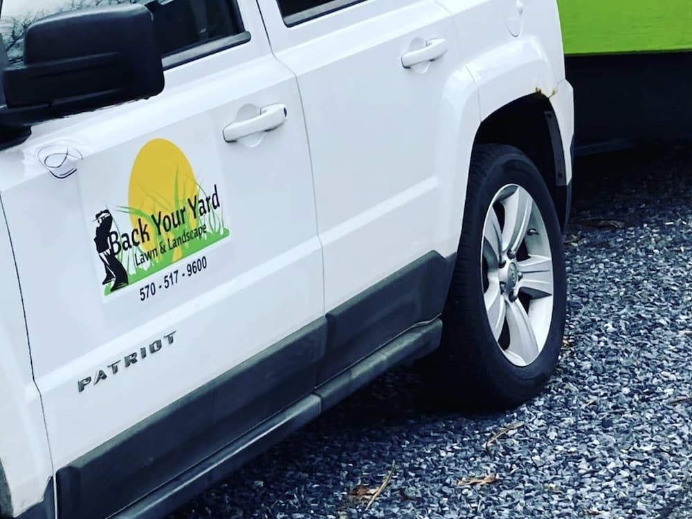 A landscaping company vehicle with a custom car decal