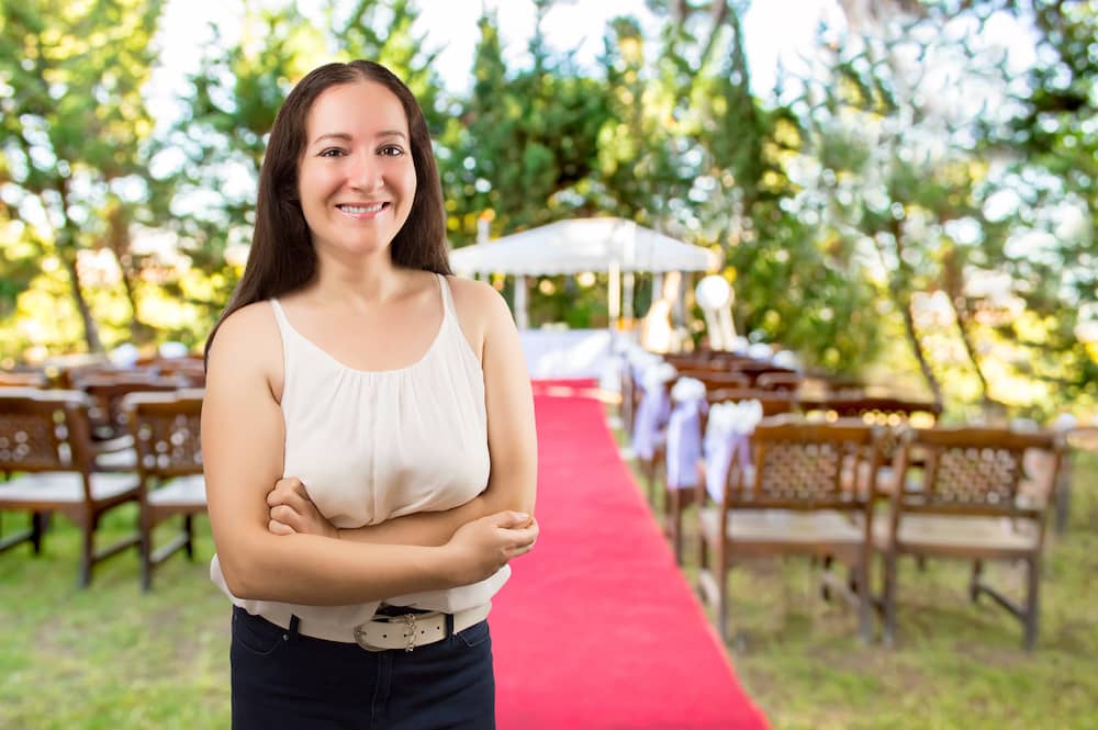 A small business owner poses at a wedding