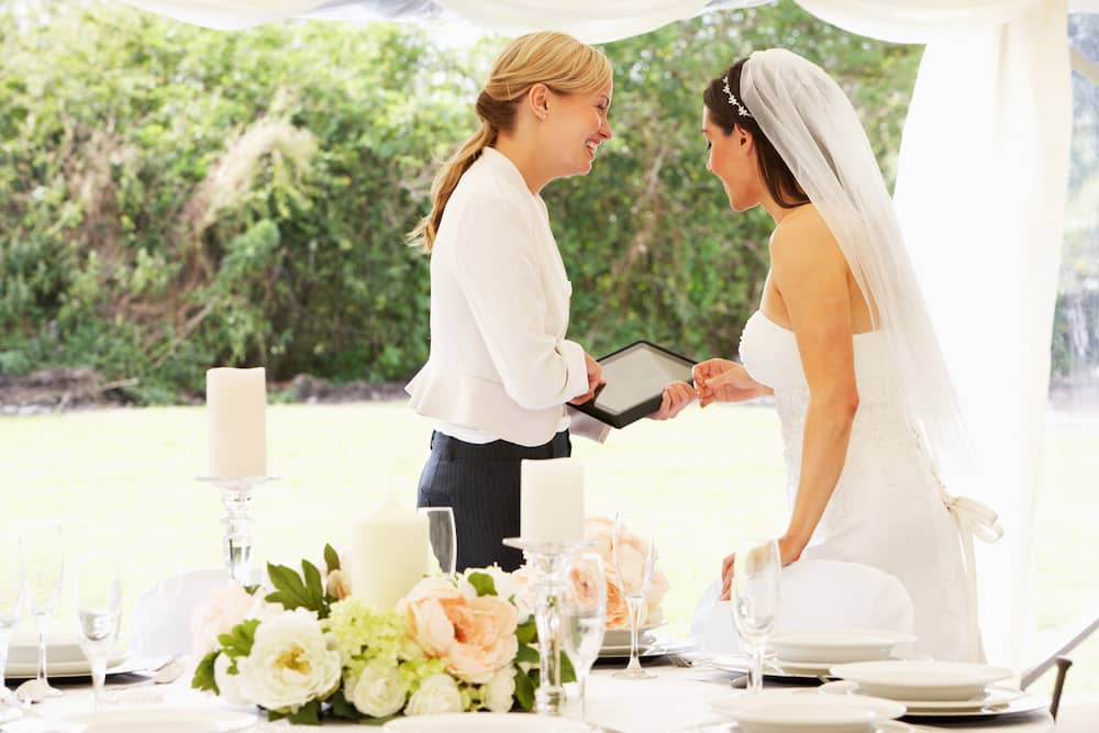 A wedding vendor speaks with a bride