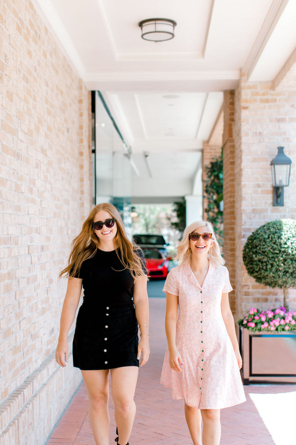 Two happy women business owners walking on a sidewalk