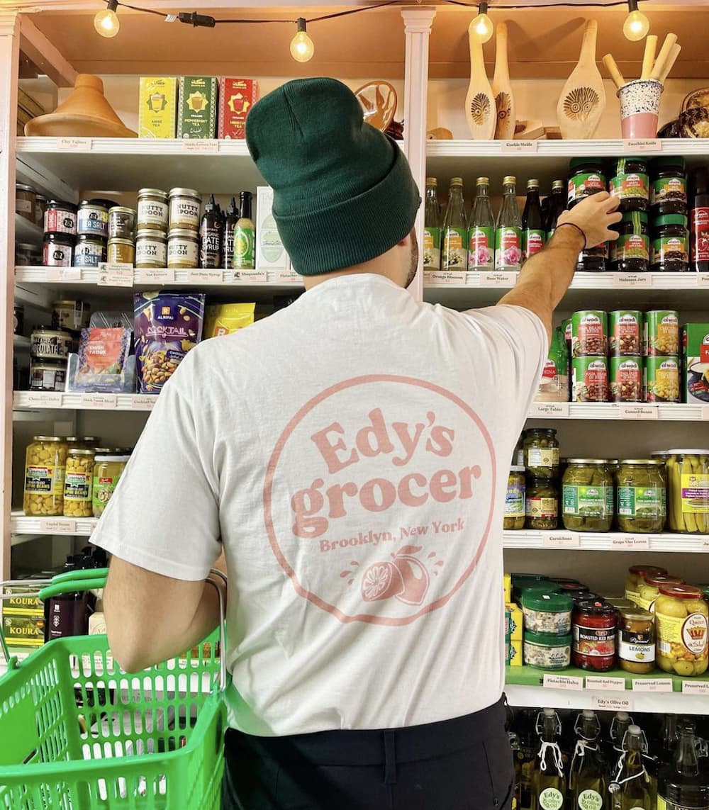 A grocery store patron wearing a custom branded t-shirt