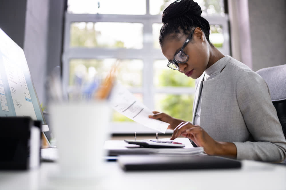 A small business owner works at a desk