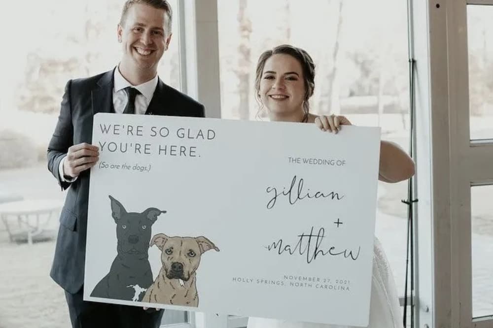 A couple holds a custom wedding poster