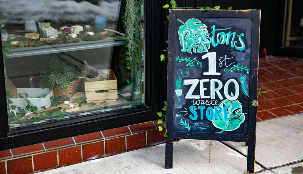 A retail window display with an A-frame sign outside