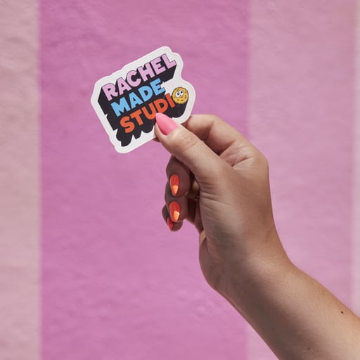 A person holds a custom die-cut sticker single