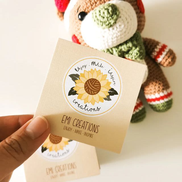 A custom business card with a crochet animal in the background